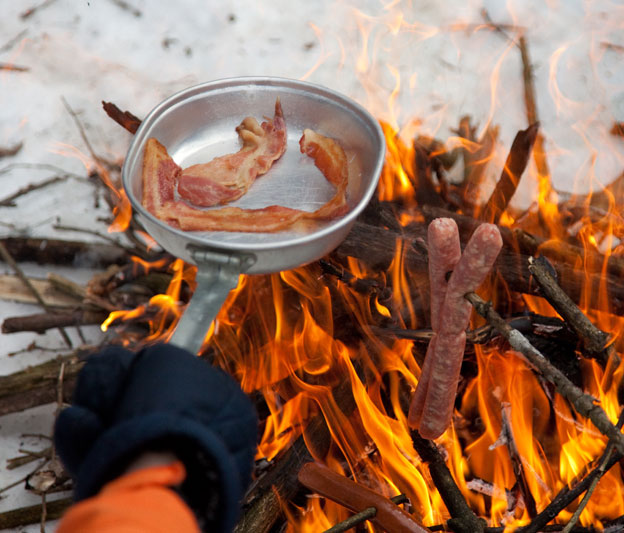 cooking over a campfire at lotus lake discovery center